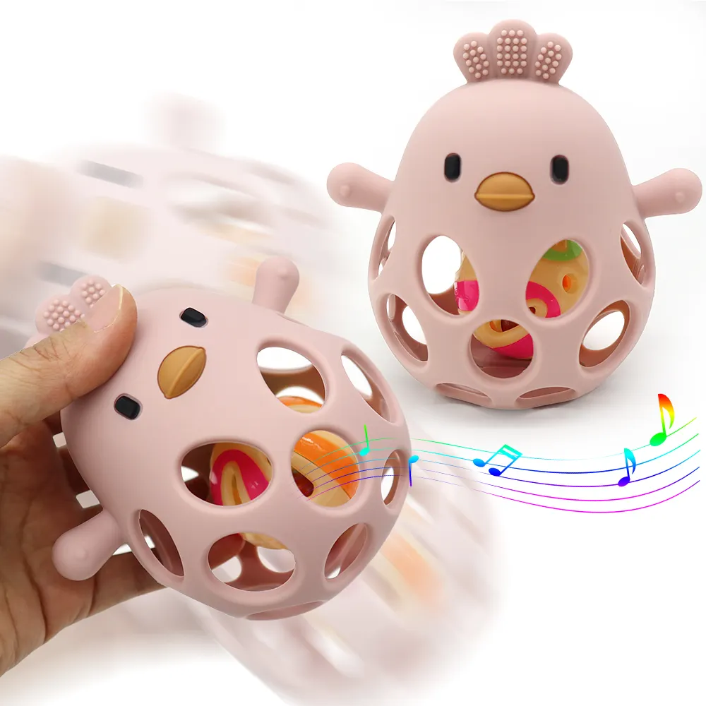 Hollow chick design silicone teether rattle in pink, with built-in bell, held in hand, making sound with colorful musical notes.