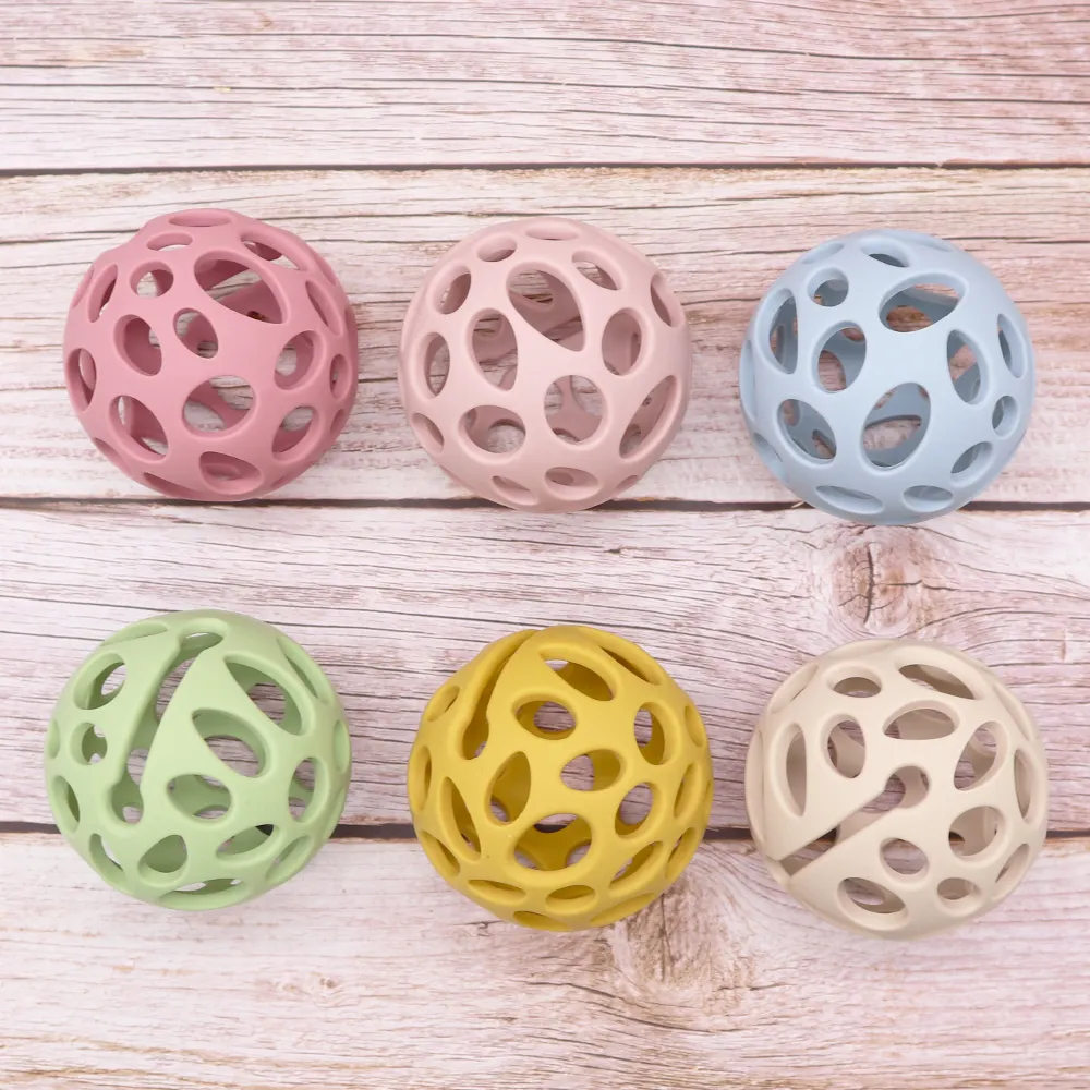 Six color hollow round silicone teething balls for babies, BPA-free chew toys displayed on wooden background