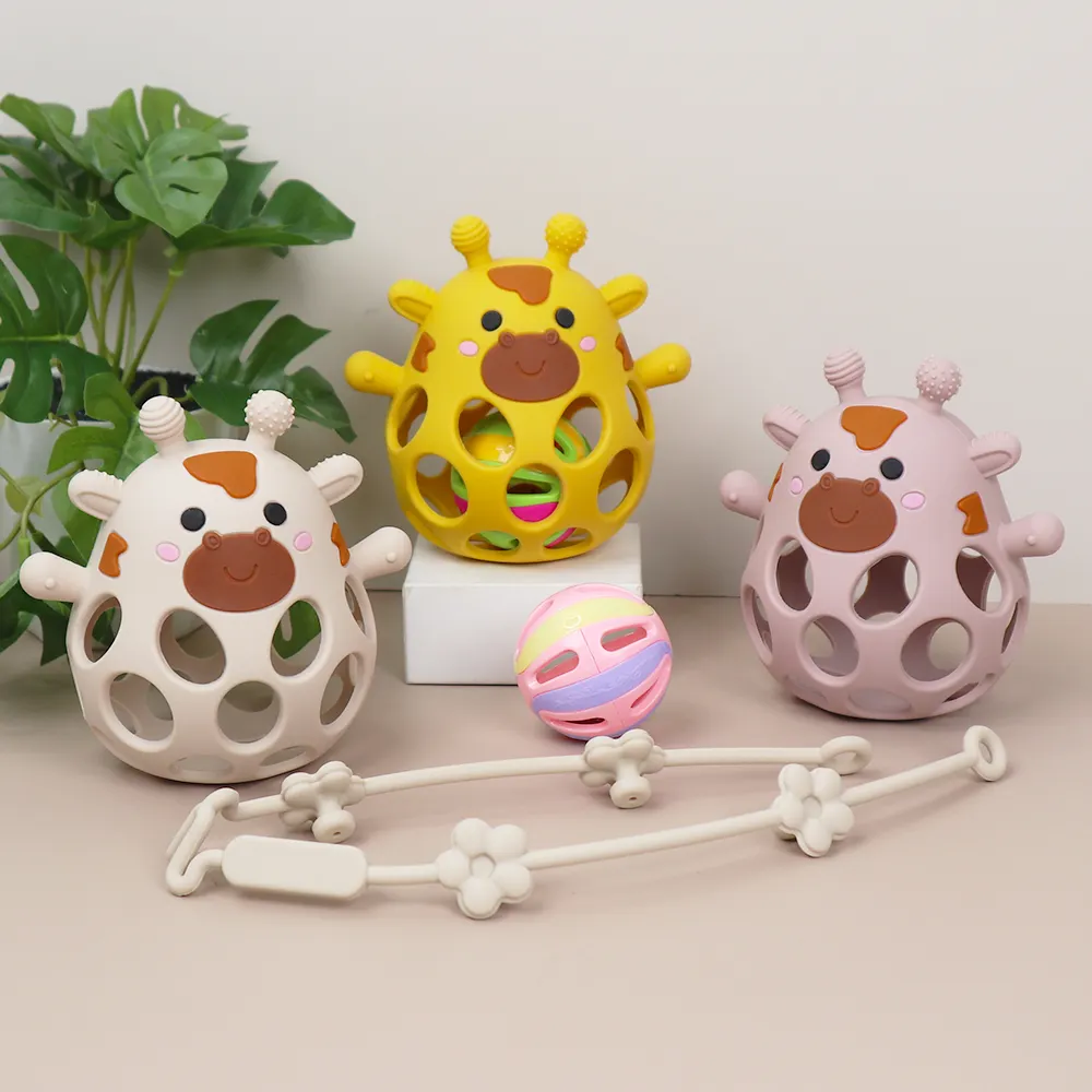 Set of hollow silicone giraffe teether balls in beige, mango yellow, and rose pink with rattle ball and silicone strap