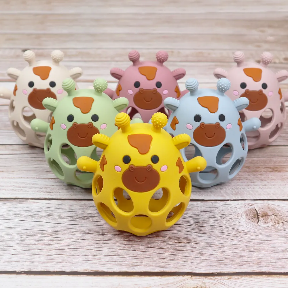 Collection of hollow silicone giraffe teether balls in multiple colors on a wooden background, BPA-free chew toys for babies